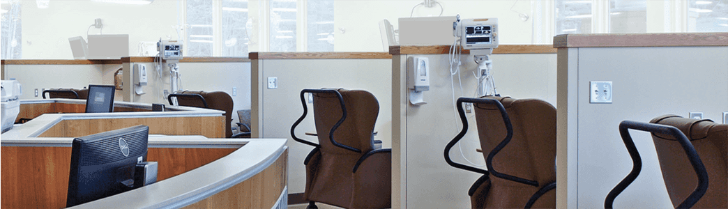 Infusion clinic with chairs and cubicles.