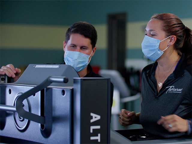 Two healthcare providers looking at diagnostic machine.